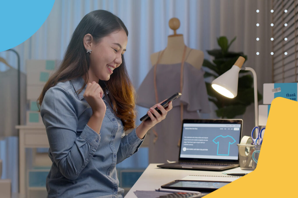 Fashion designer using phone in studio