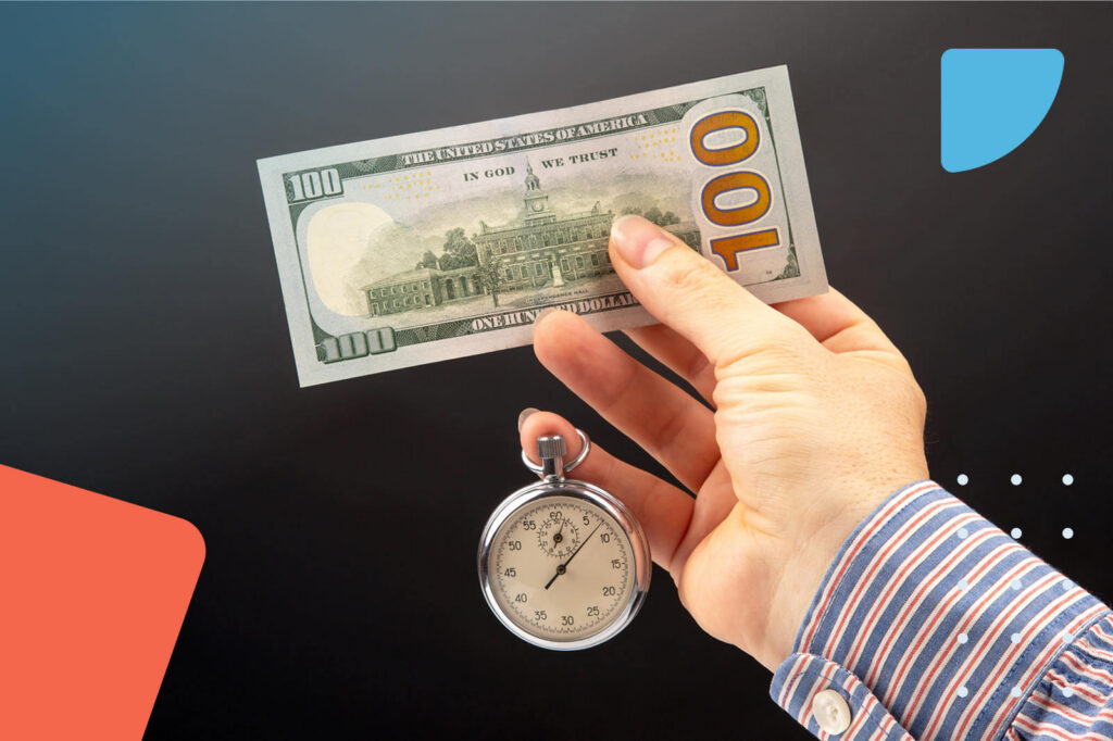 Hand holding money and stopwatch