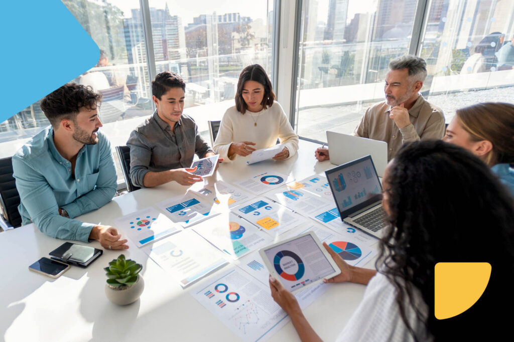 Business team analyzing charts in boardroom