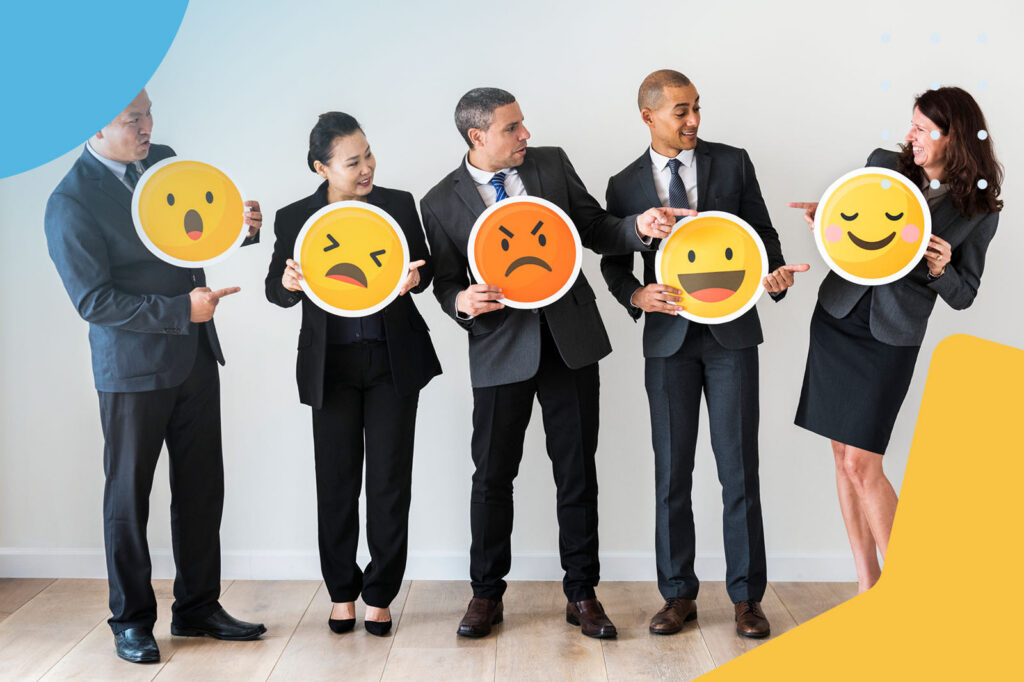 Business people holding emoji feedback signs