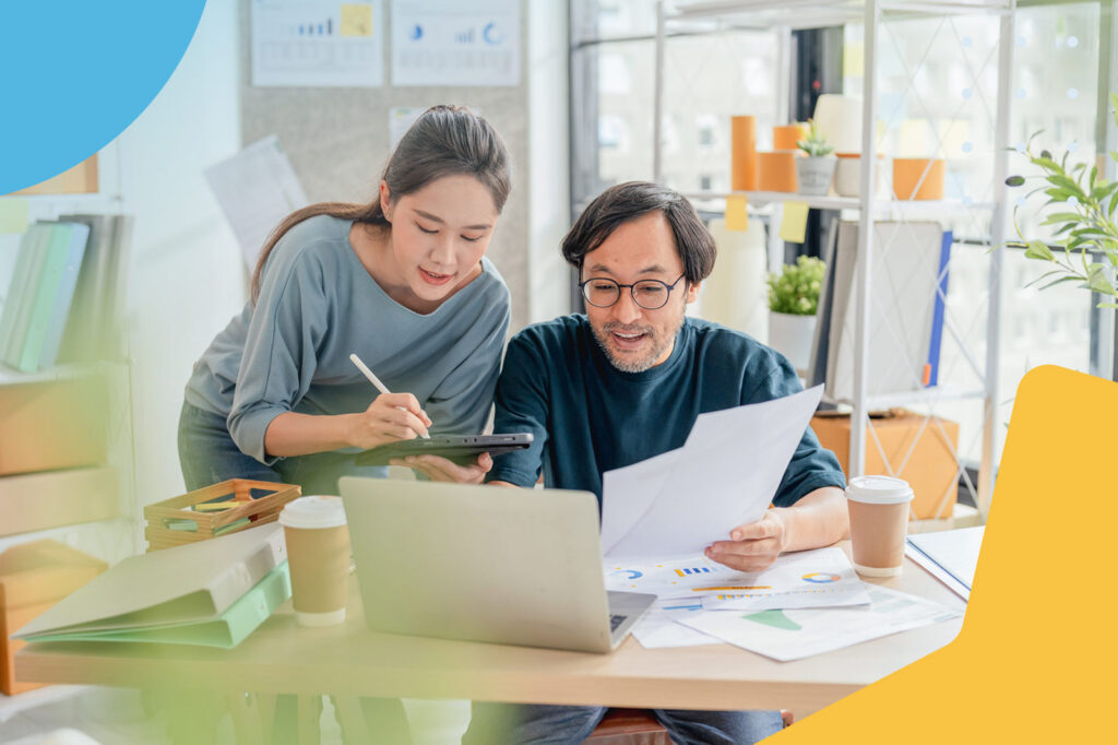 Colleagues reviewing documents at desk