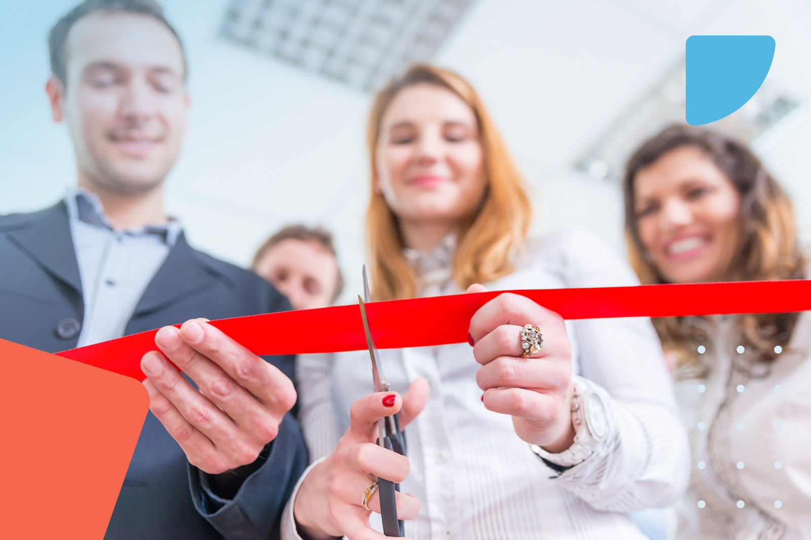 Woman cutting red opening ribbon