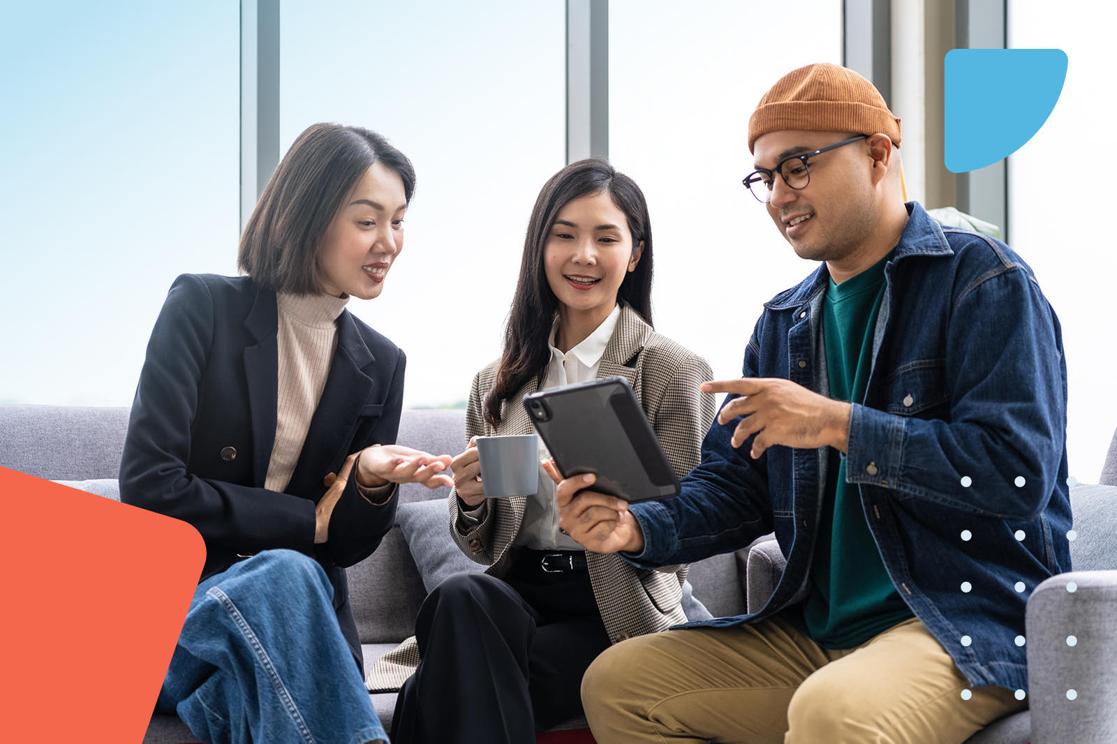 Colleagues discussing tablet in office
