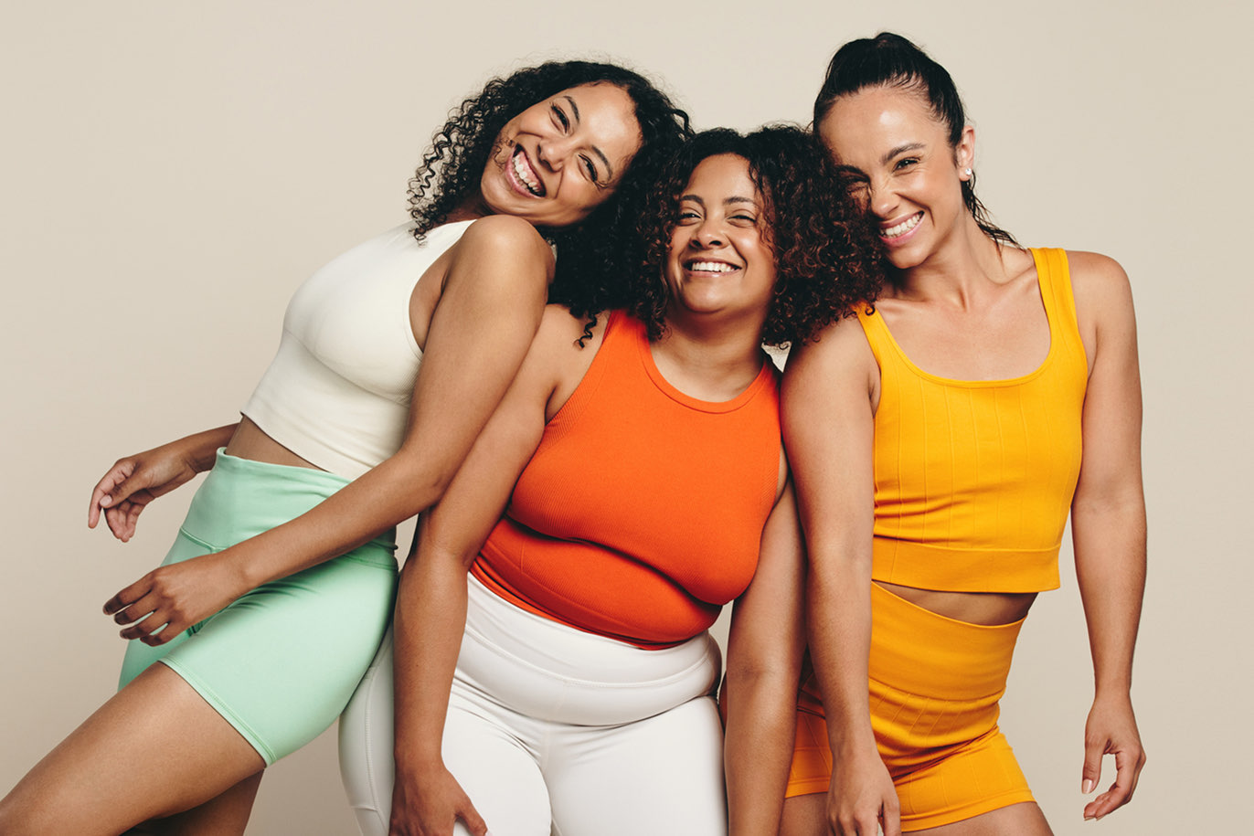 Three women in colorful activewear