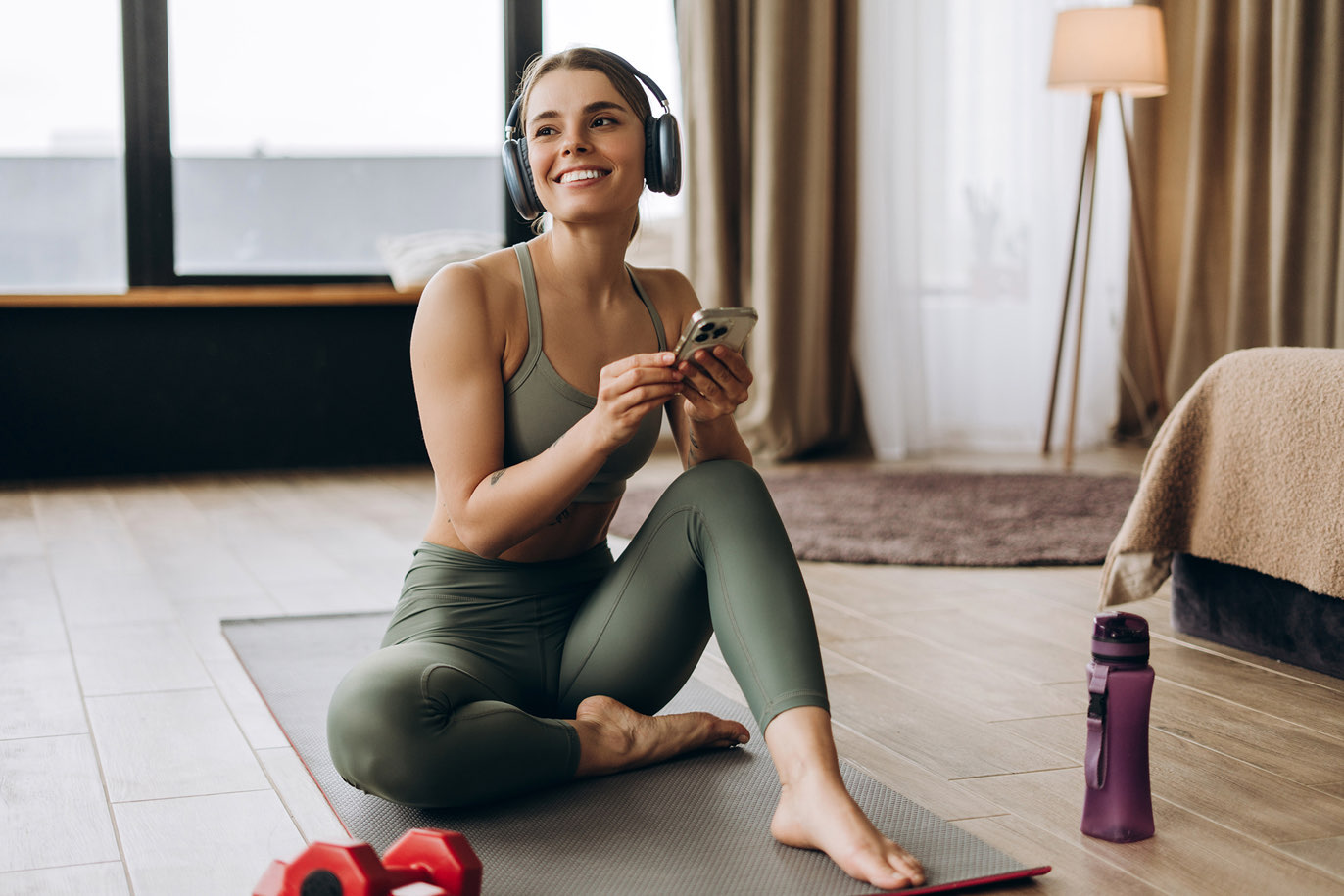 Woman with headphones using phone