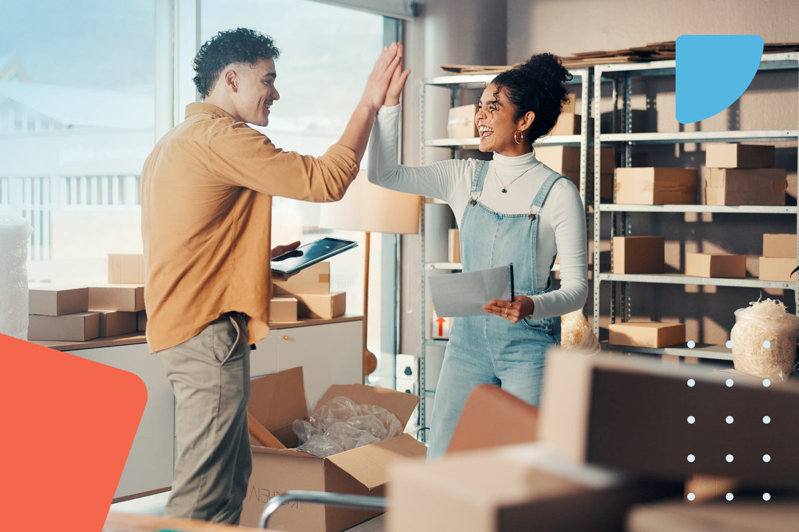 Coworkers high-fiving in warehouse
