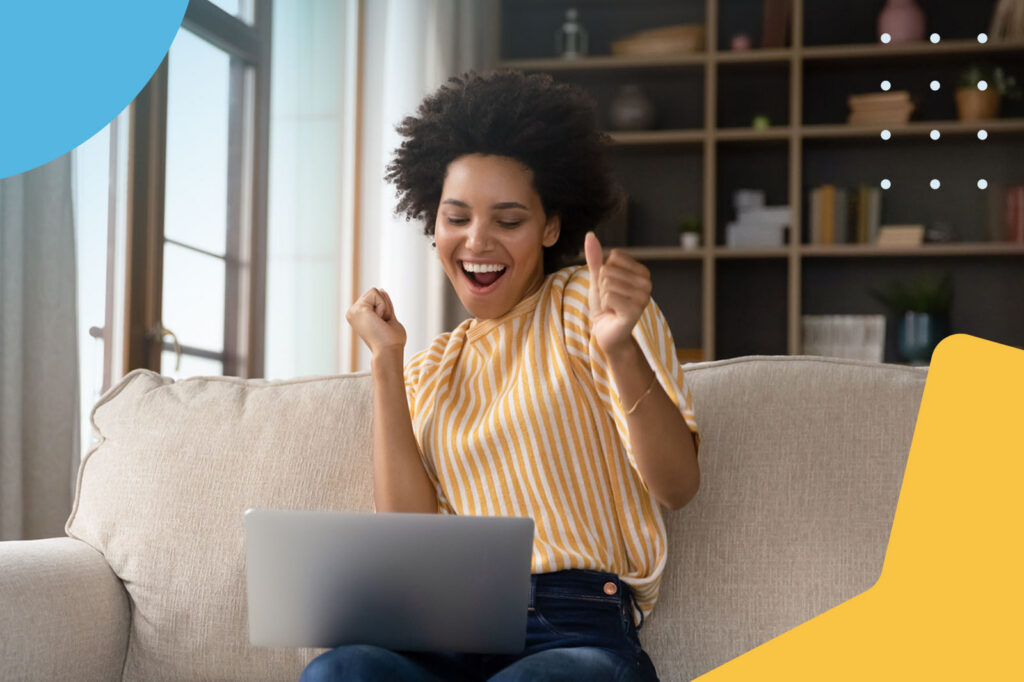 Excited woman with laptop cheering