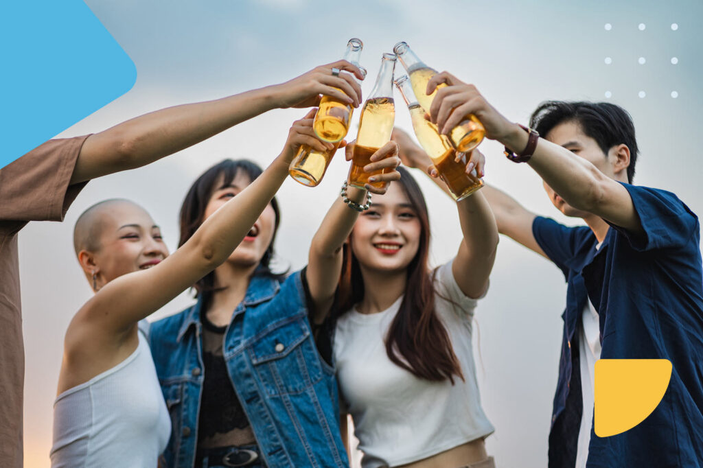 Friends toasting with beer bottles