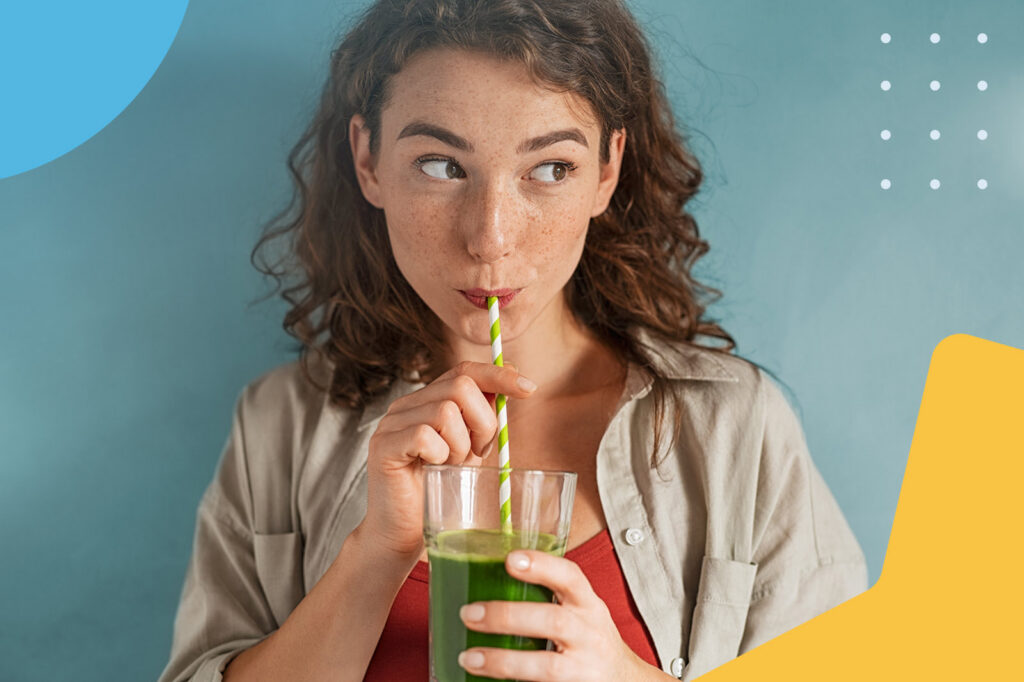 Woman drinking green juice