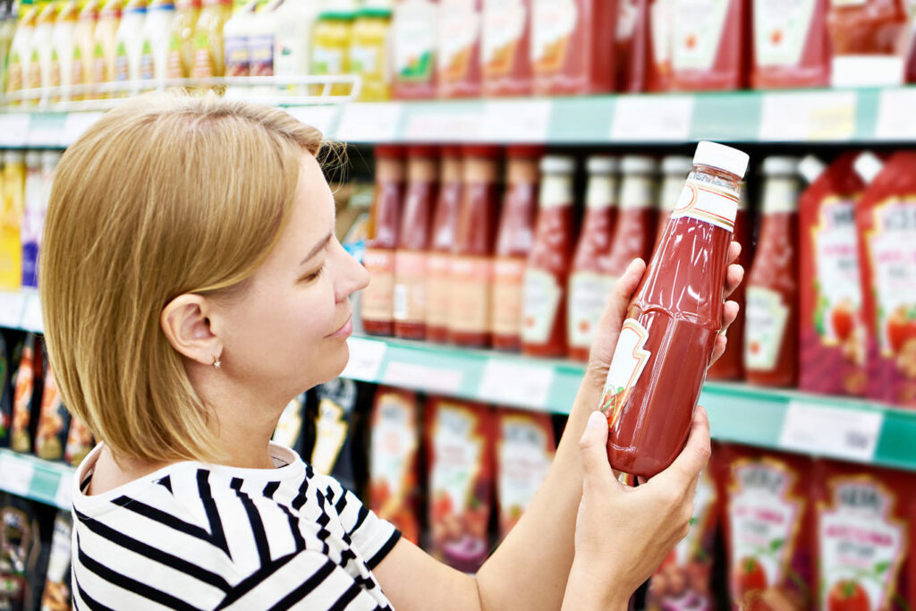 Woman holding tomato ketchup bottle