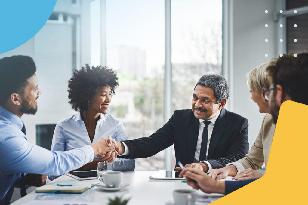 Five Ways eCommerce Brands Can Leverage Affiliate Marketing 5 Business executives shaking hands during a meeting