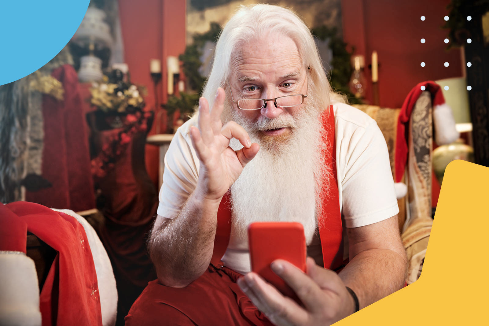 Santa Claus holding a smartphone and making an OK sign