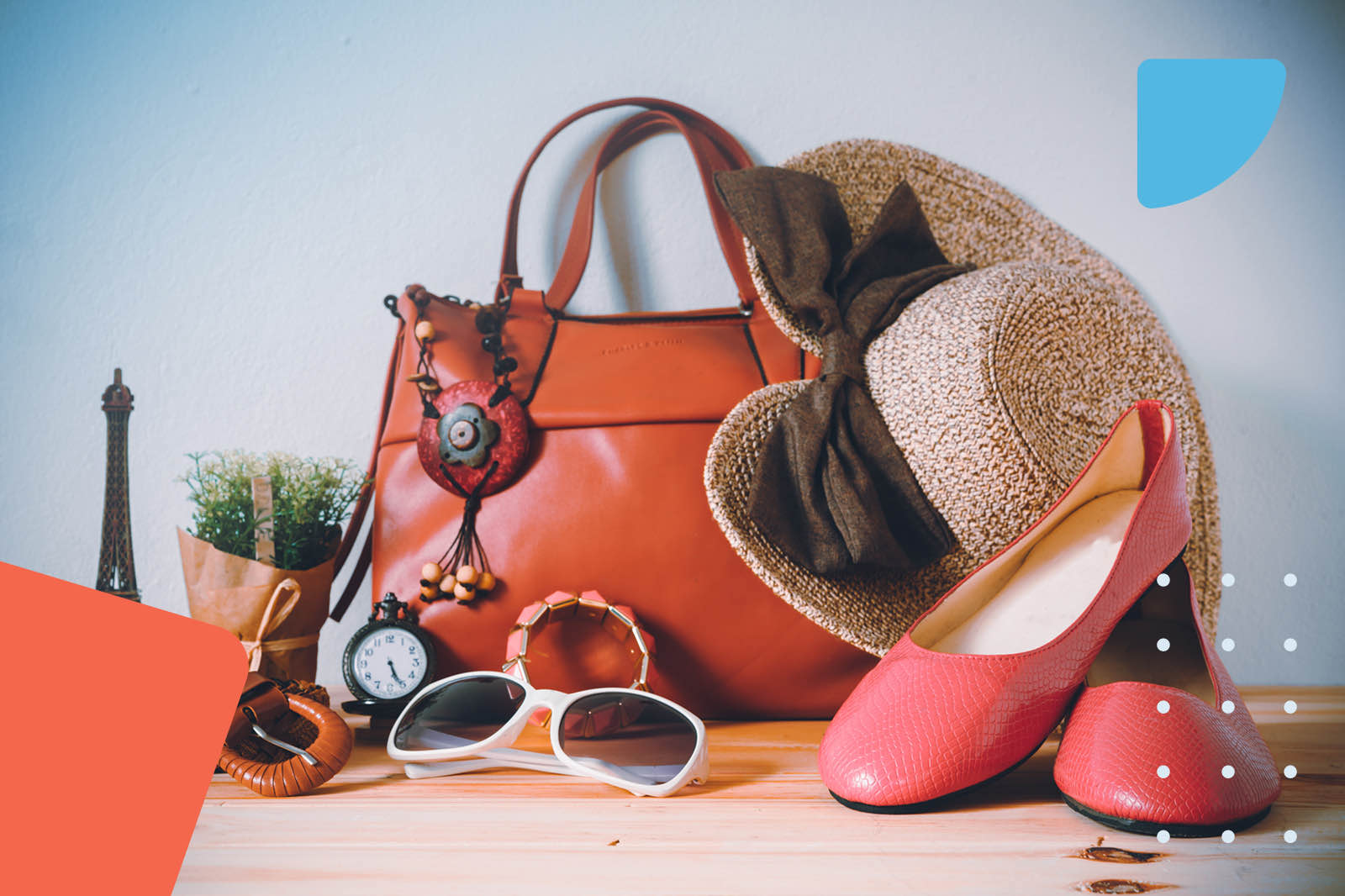Flat lay of fashion accessories including handbag, hat, and shoes