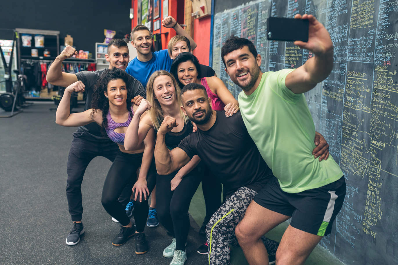 Diverse group of gym friends taking a group selfie