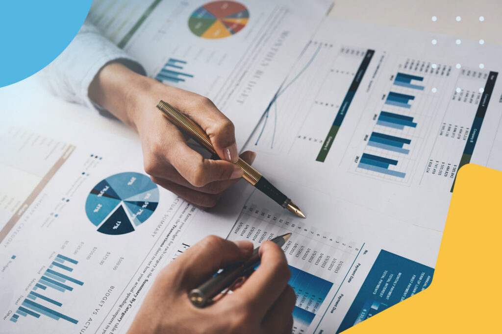 Close-up of hands reviewing financial charts and data