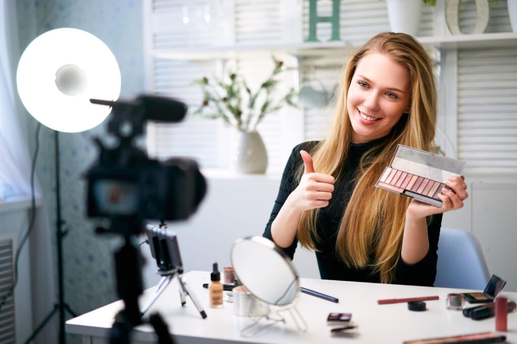 Female influencer filming with a product