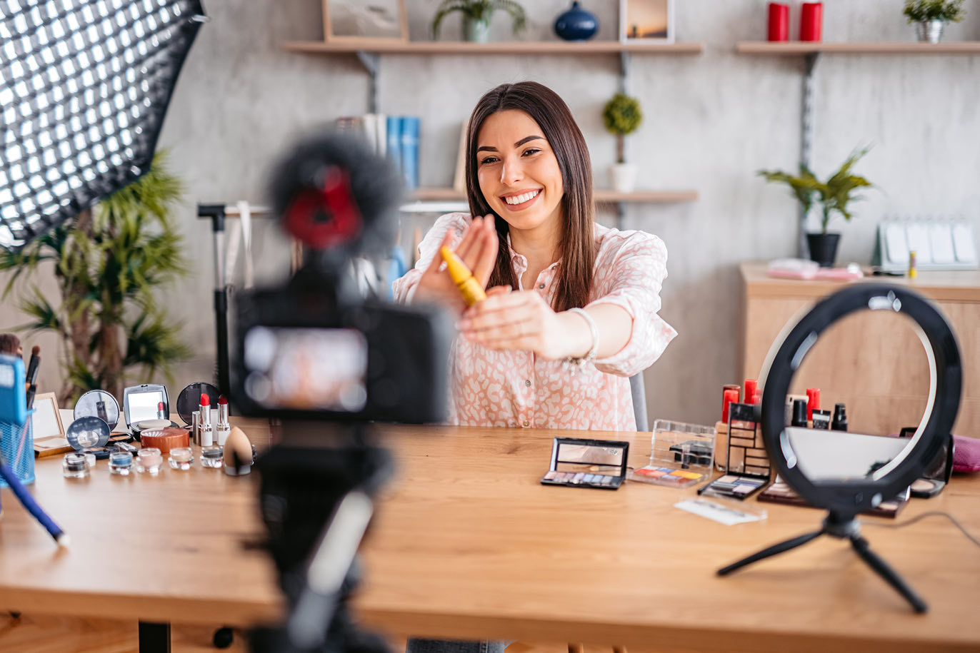 Beauty influencer recording a makeup tutorial with a ring light