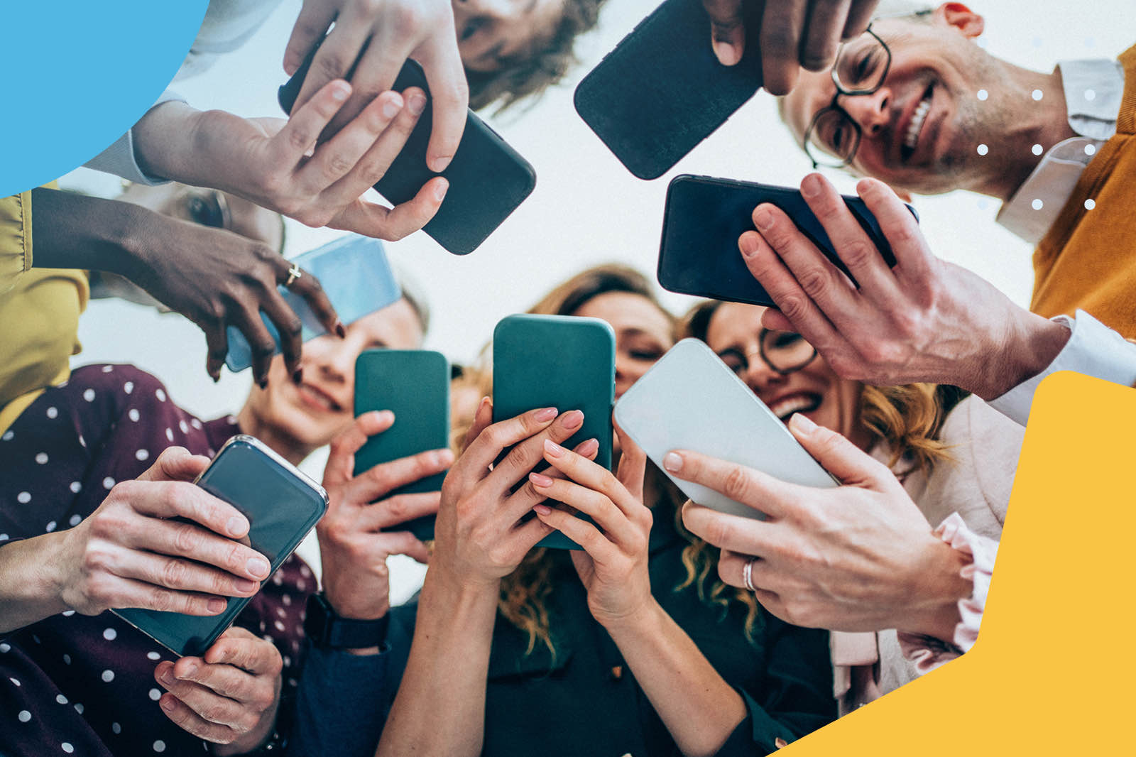 Group of people taking a collective selfie with smartphones