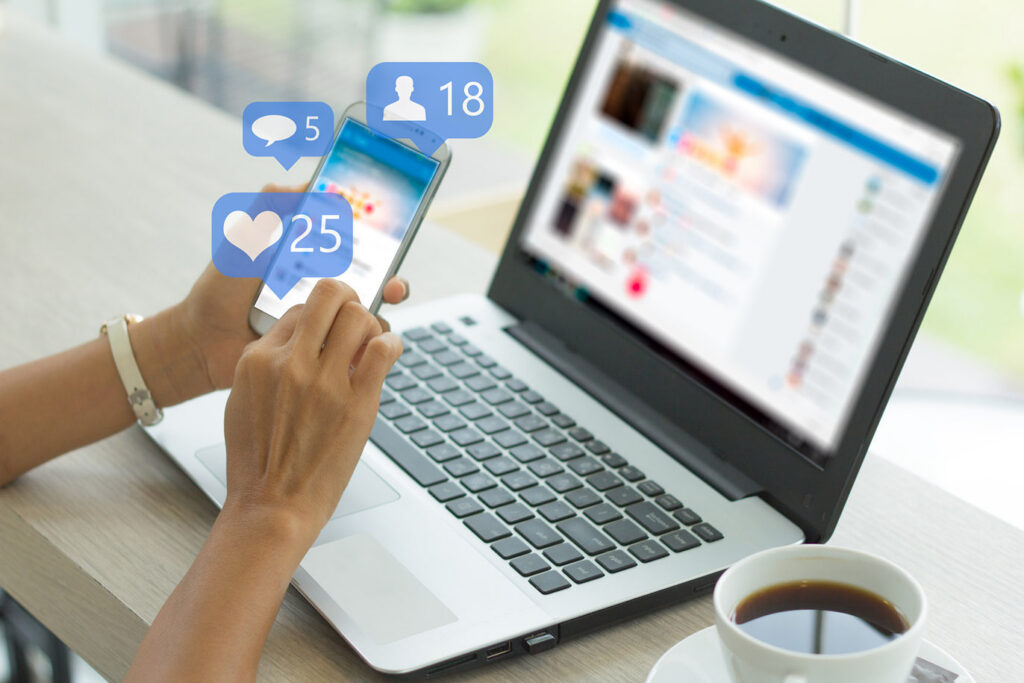 Person using smartphone with social media notification icons