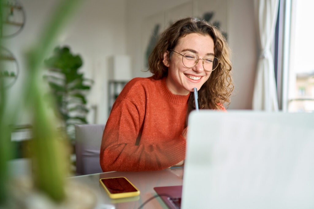 Smiling woman on a video call using a laptop