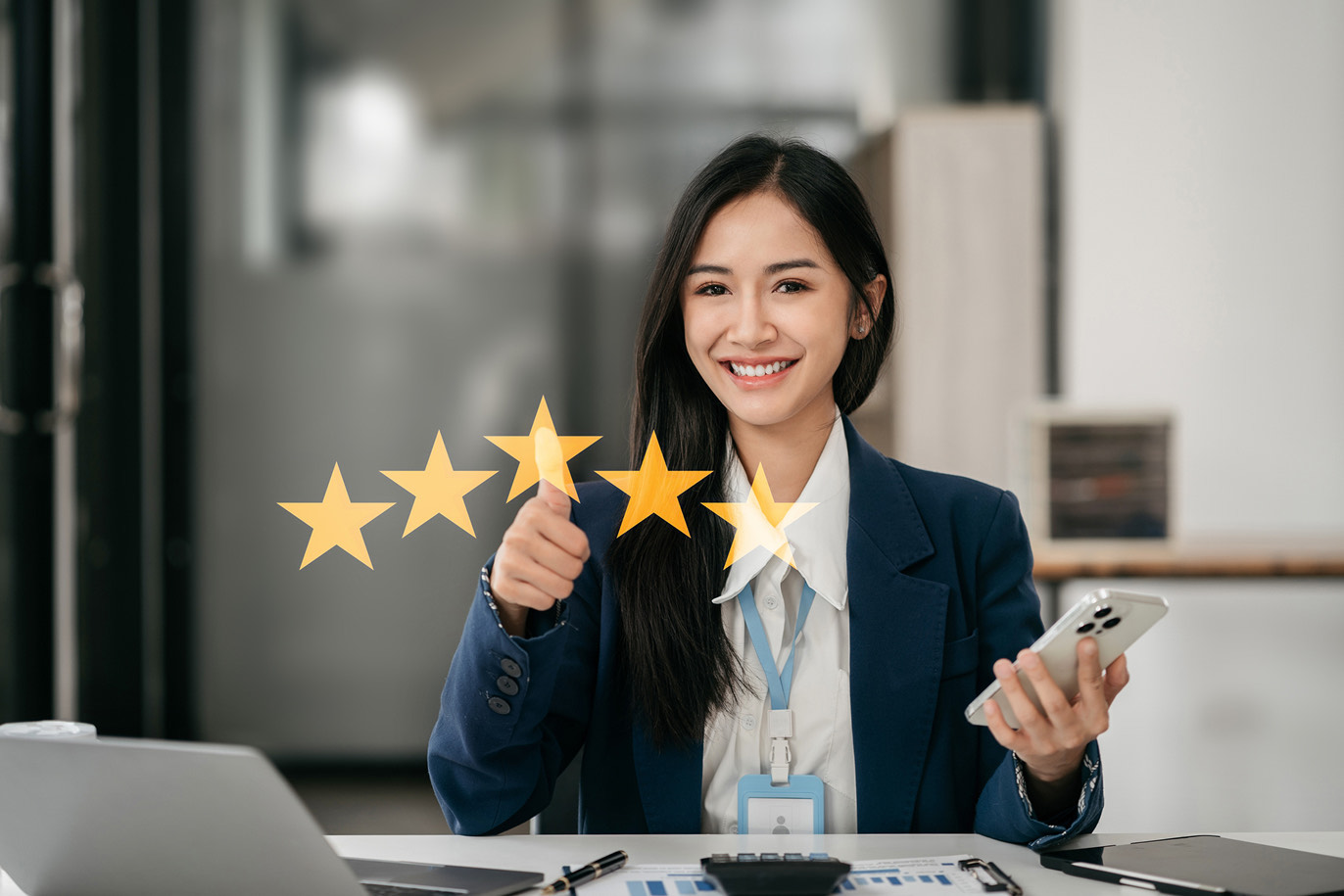 Businesswoman giving a thumbs up for five-star rating