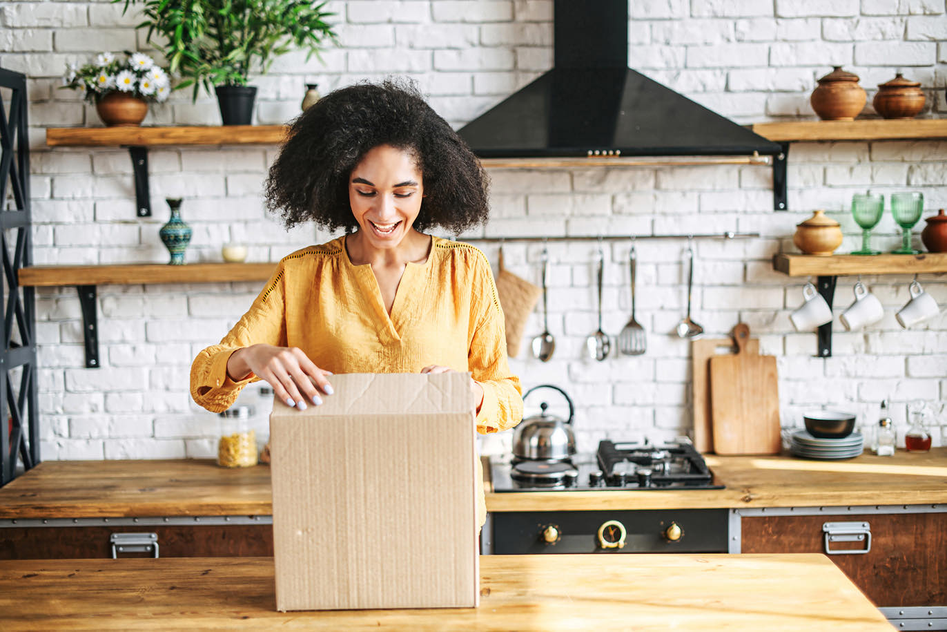 Woman unboxing a package in a kitchen