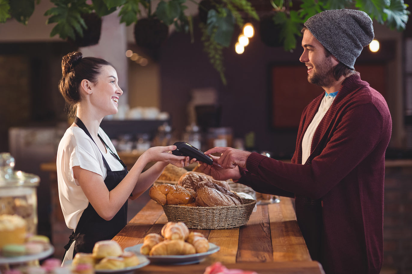 Man paying at a bakery counter