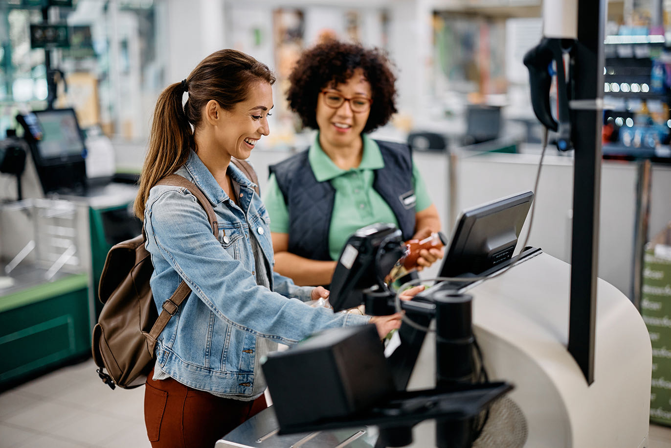 Woman using a self-checkout terminal