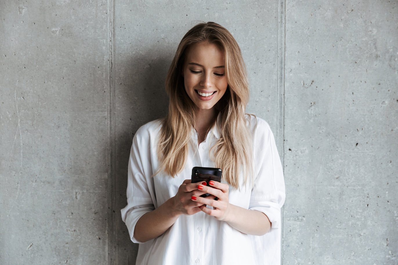Woman smiling on her phone