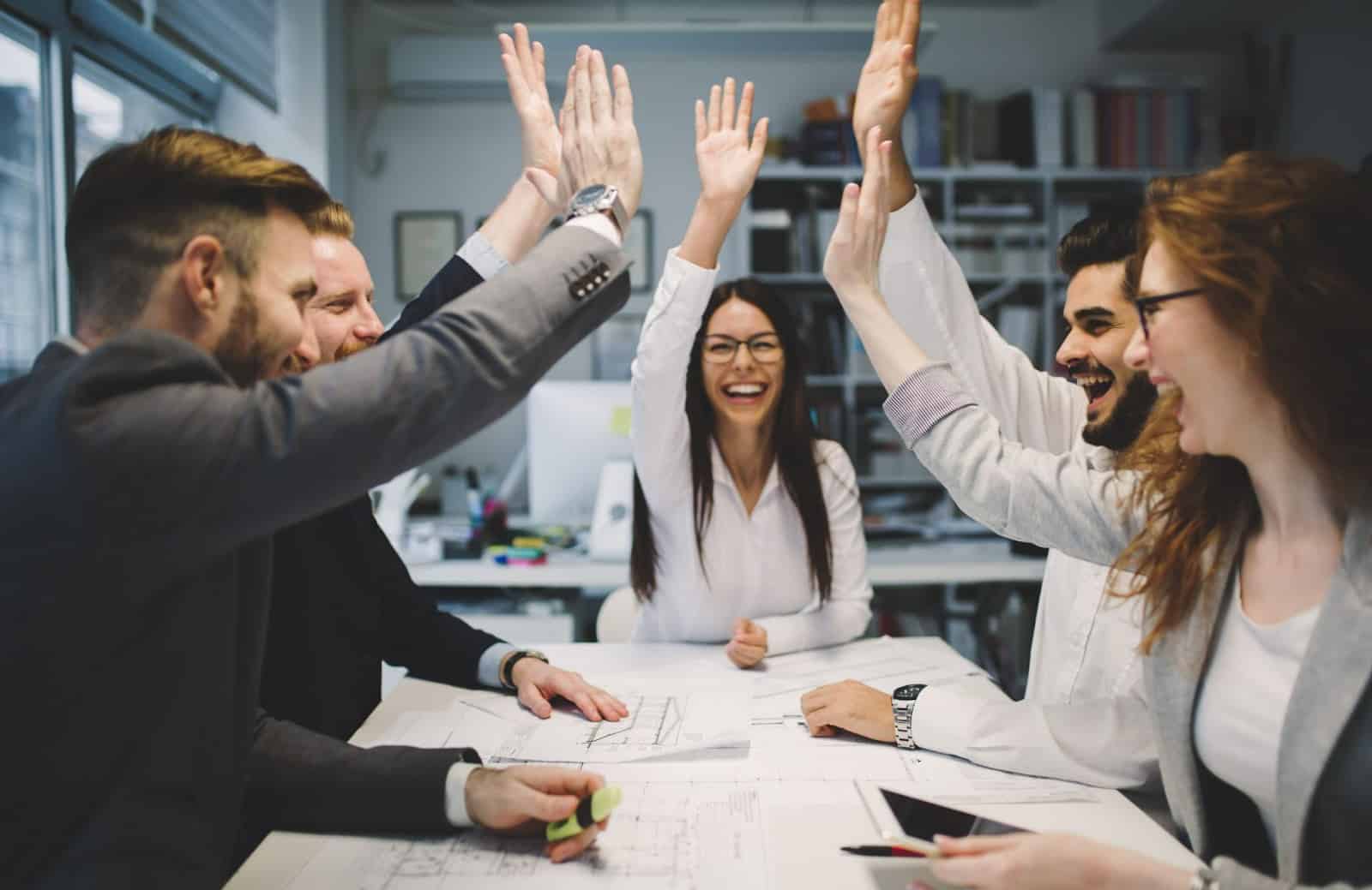 People giving high fives at office