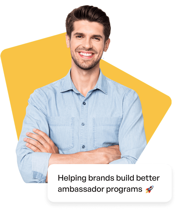 Smiling man in a light blue shirt with text saying 'Helping brands build better ambassador programs'
