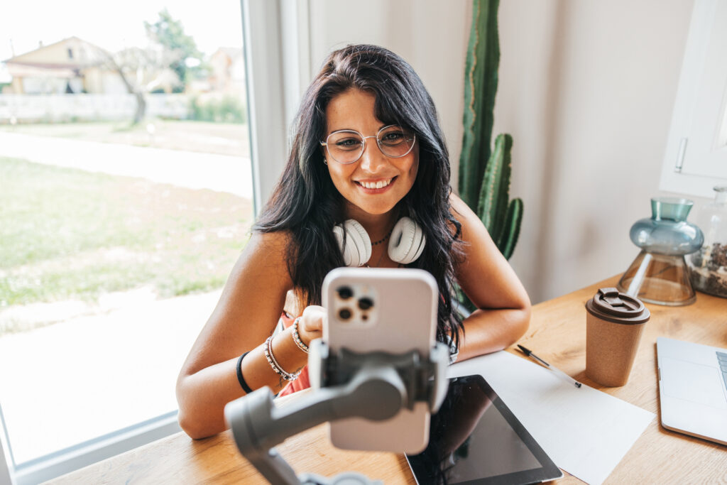 Woman influencer speaks to her followers in live streaming from home.