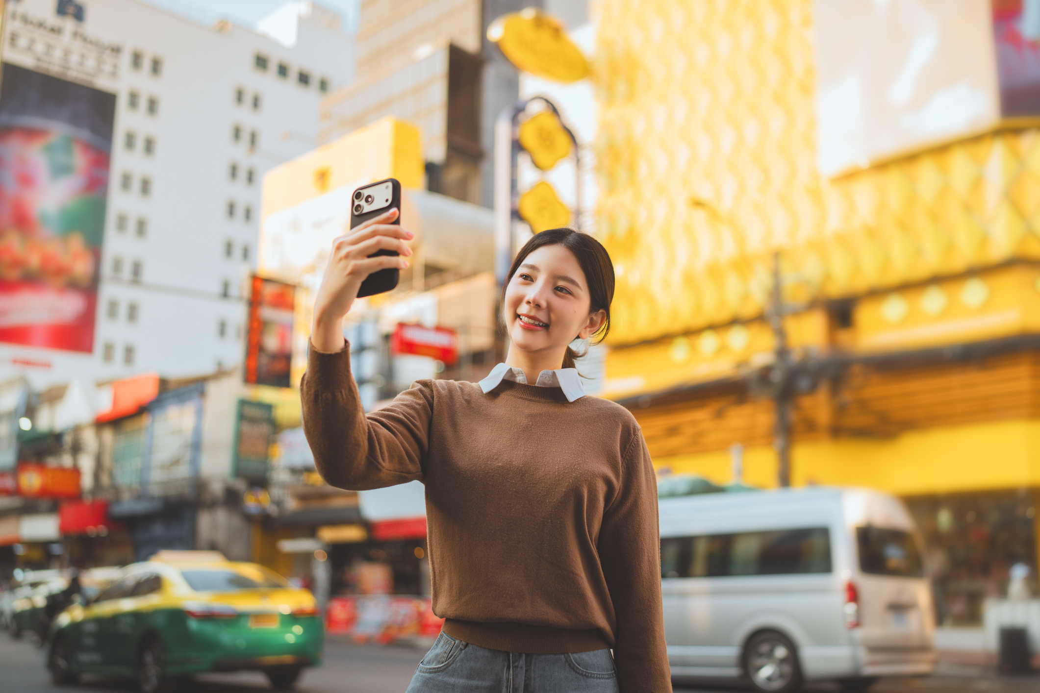 Happy influencer marketing. Selfie with smartphone at Yaowarat Road.