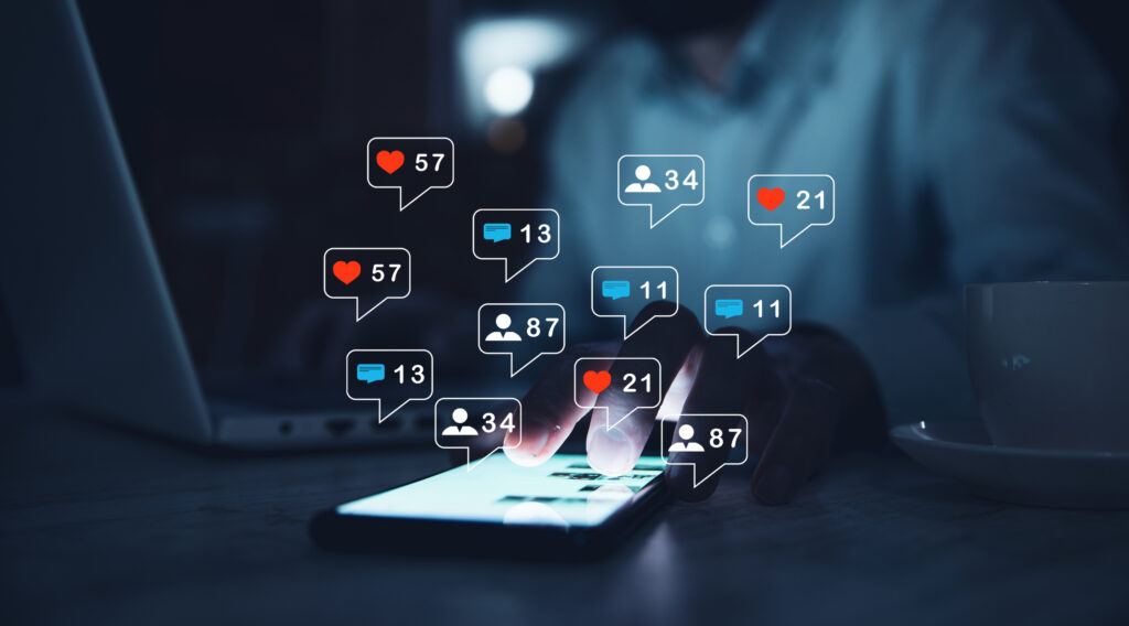 Phone showing likes, comments, and follower counts stacking up, the kind of affiliate activity an affiliate management system needs to track