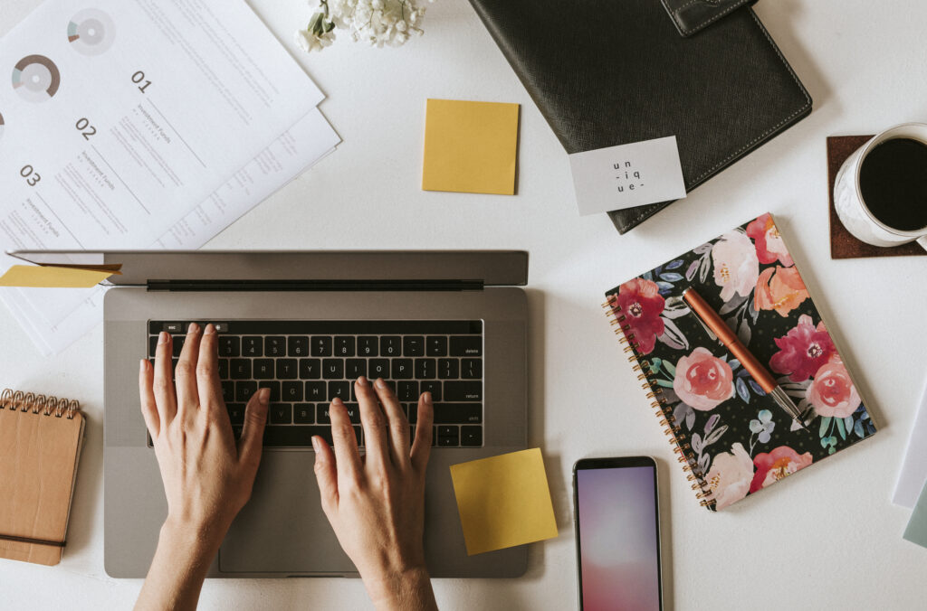 Workspace with laptop, notes, and planning materials representing the day-to-day process behind affiliate management