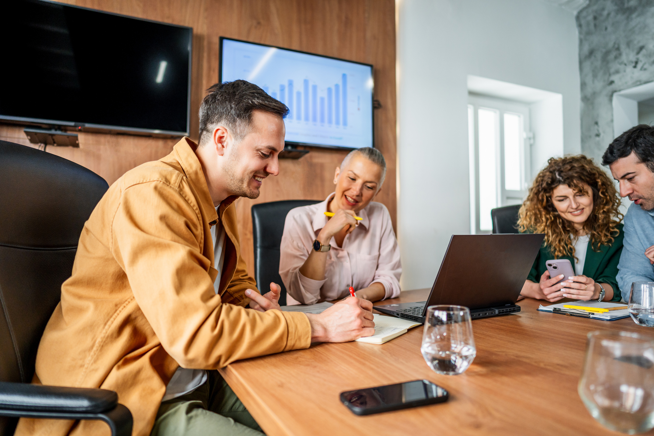 Team reviewing program performance and strategy in a meeting about affiliate management